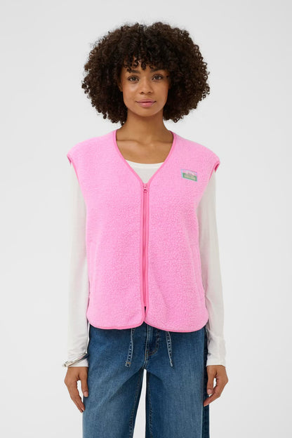 Person wearing a pink vest with a visible brand logo on a white background