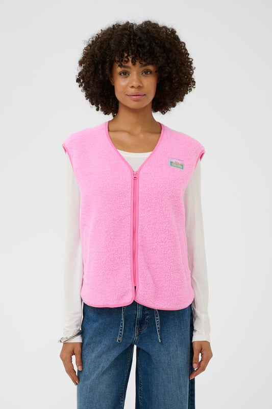Person wearing a pink vest with a visible brand logo on a white background