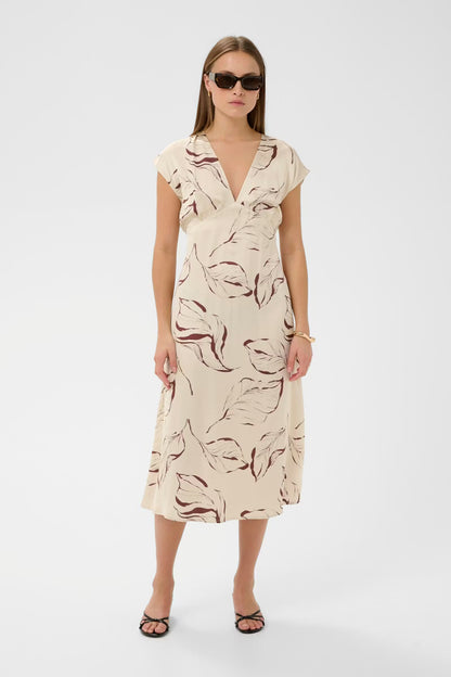Woman wearing a patterned dress on a white background