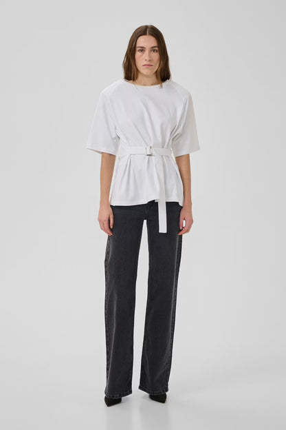 Person wearing a white top and black pants on a white background