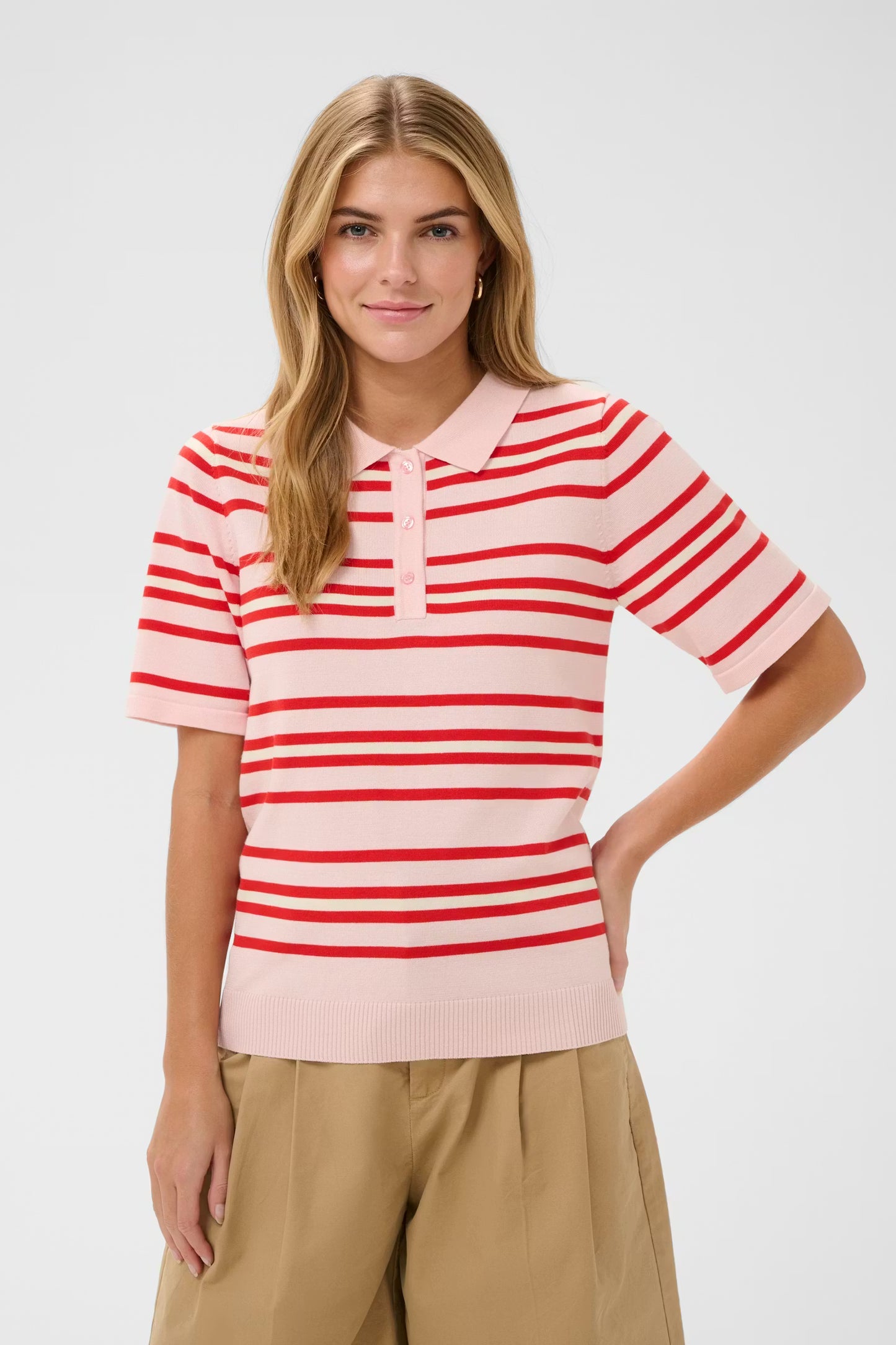 Woman wearing a red and white striped shirt with a plain background
