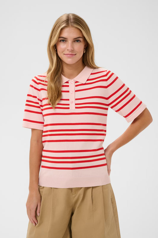 Woman wearing a red and white striped shirt with a plain background