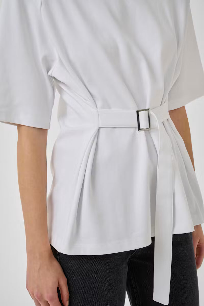White blouse with a belt tied around the waist on a white background