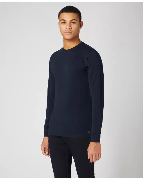 Man wearing a black long-sleeve shirt against a light gray background