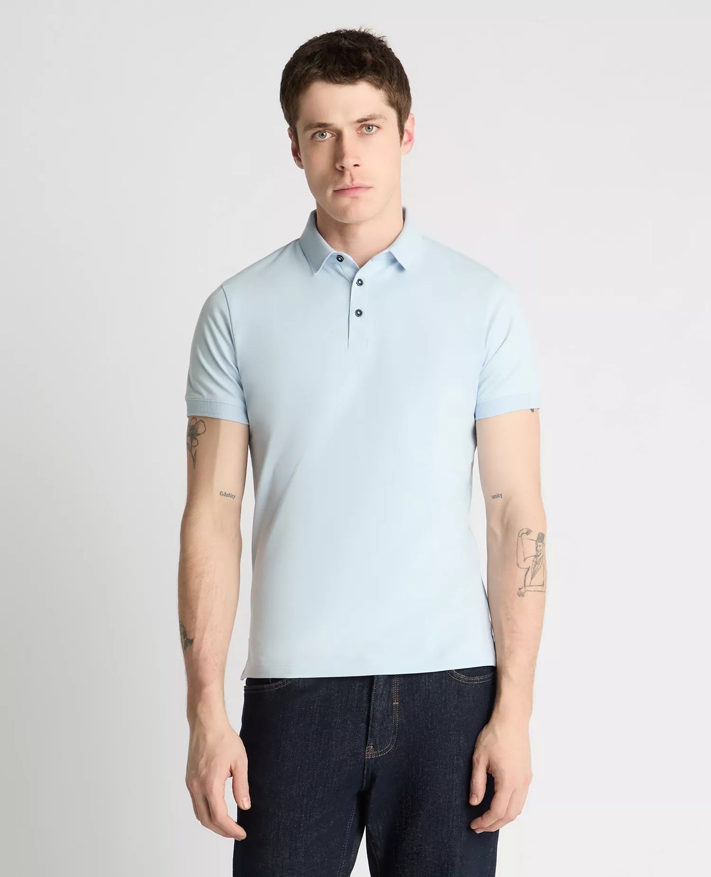Man wearing a light blue polo shirt against a plain background