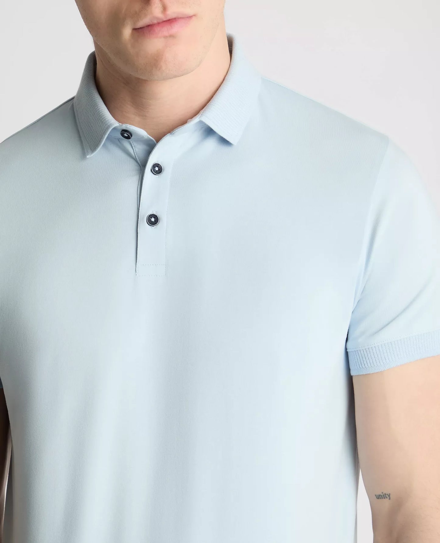 Light blue polo shirt worn by a person on a plain background