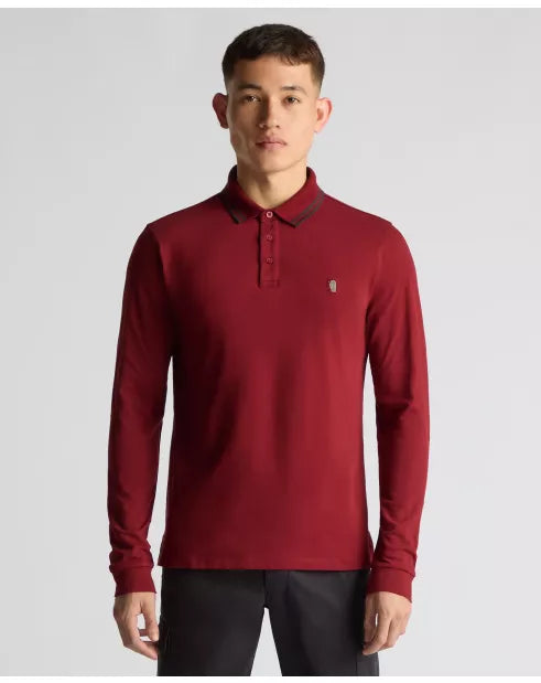 Man wearing a red long-sleeve polo shirt on a gray background