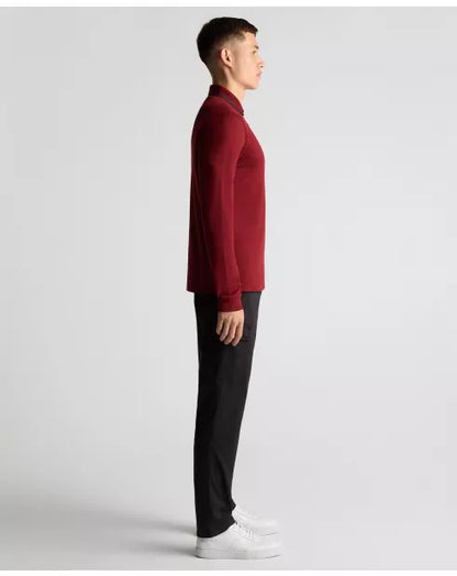 Person wearing a red sweater and black pants on a light gray background