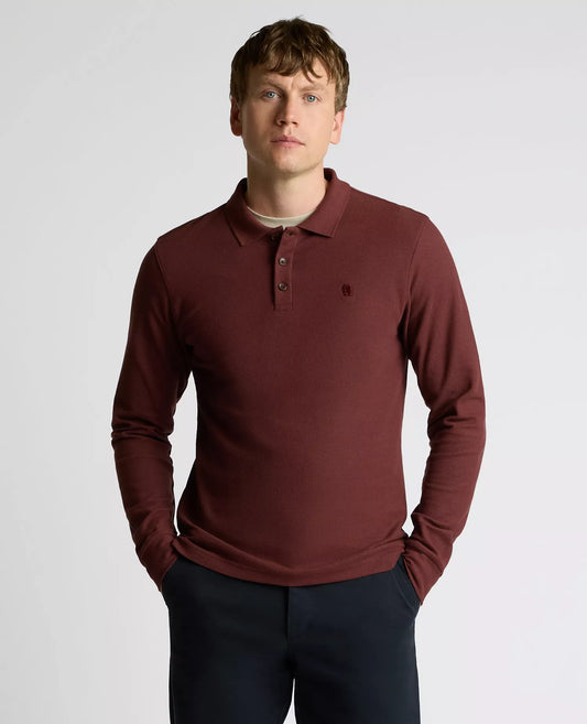 Man wearing a maroon long-sleeve polo shirt on a light gray background