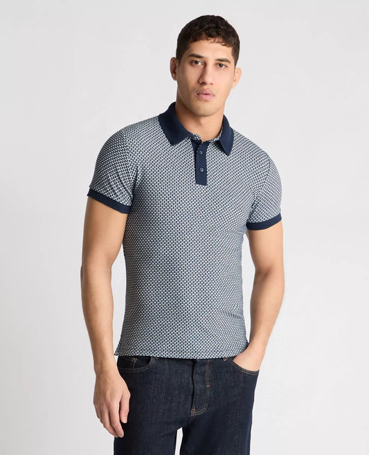 Man wearing a patterned polo shirt with navy accents on a light gray background