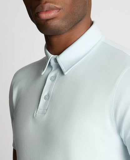 Light gray polo shirt worn by a person on a plain background