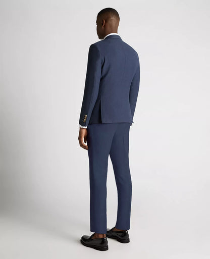 Man wearing a blue suit standing against a white background