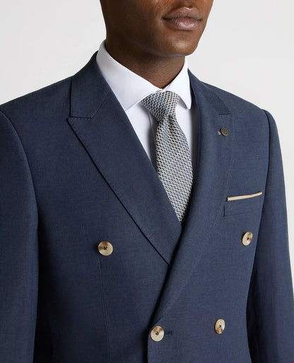 Navy blue suit jacket with white shirt and patterned tie on a neutral background