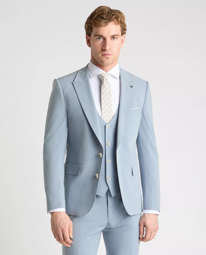 Man wearing a light blue suit with a white shirt and striped tie on a plain background