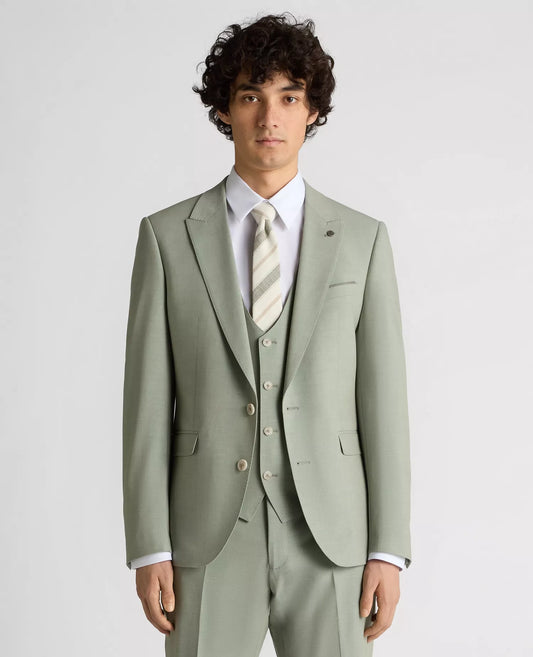 Man wearing a light green suit with a white shirt and patterned tie on a plain background