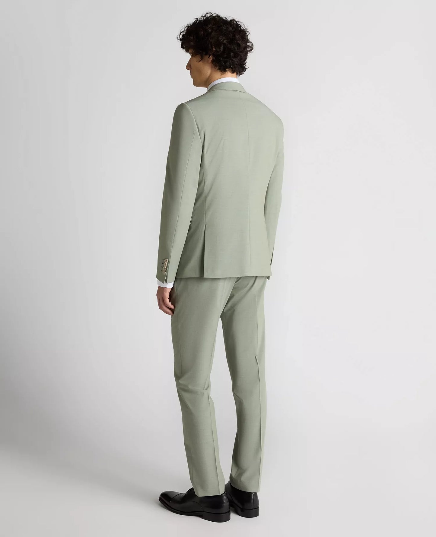 Man wearing a light green suit on a white background