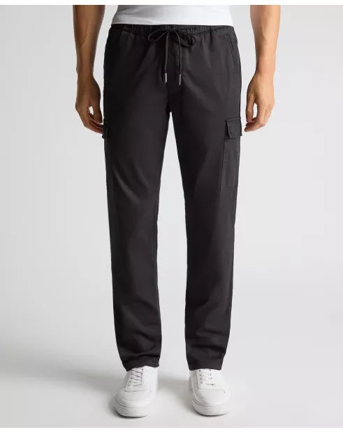 Black cargo pants worn by a person on a white background
