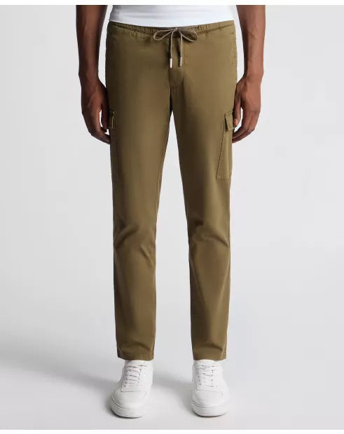 Person wearing olive green cargo pants on a white background