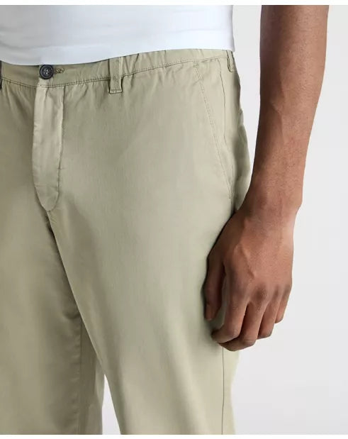Beige pants worn by a person on a white background