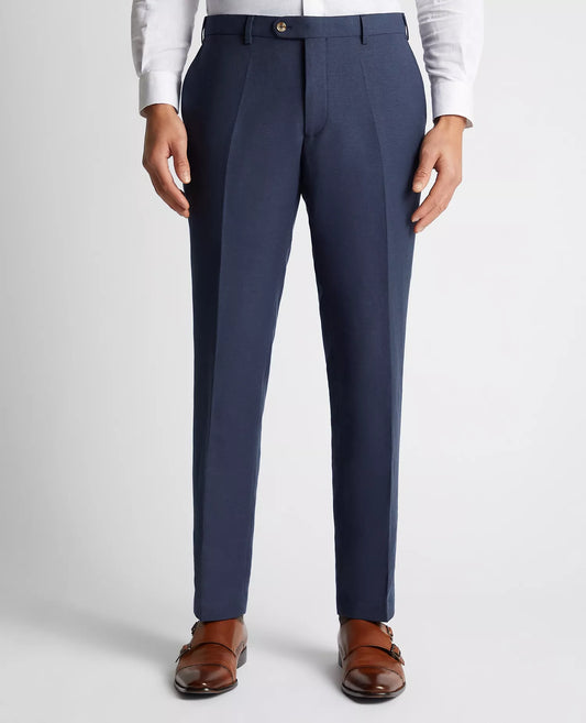 Navy blue dress pants worn with a white shirt and brown shoes on a light gray background