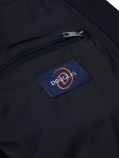 Close-up of a dark navy jacket or bag pocket with a silver zipper and a blue embroidered Douglas logo patch.