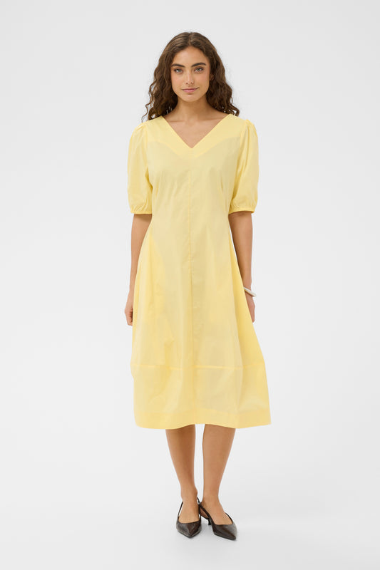 Woman wearing a yellow dress on a white background