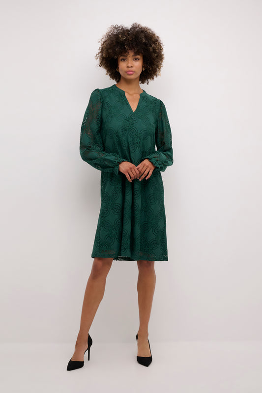 Woman wearing a green dress against a white background