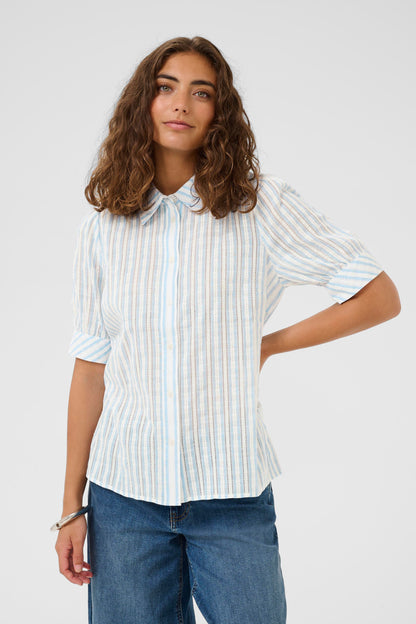 Woman wearing a white striped shirt and blue jeans on a white background