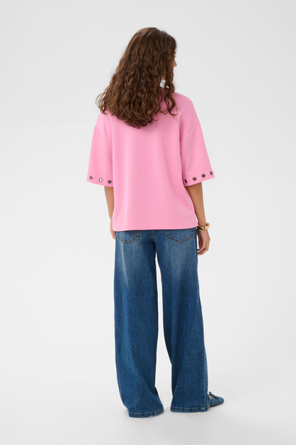 Person wearing a pink top and blue jeans on a white background