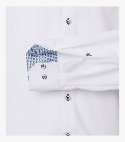 Close-up of a white dress shirt cuff with silver buttons and a blue patterned inner lining, shown against a white background.