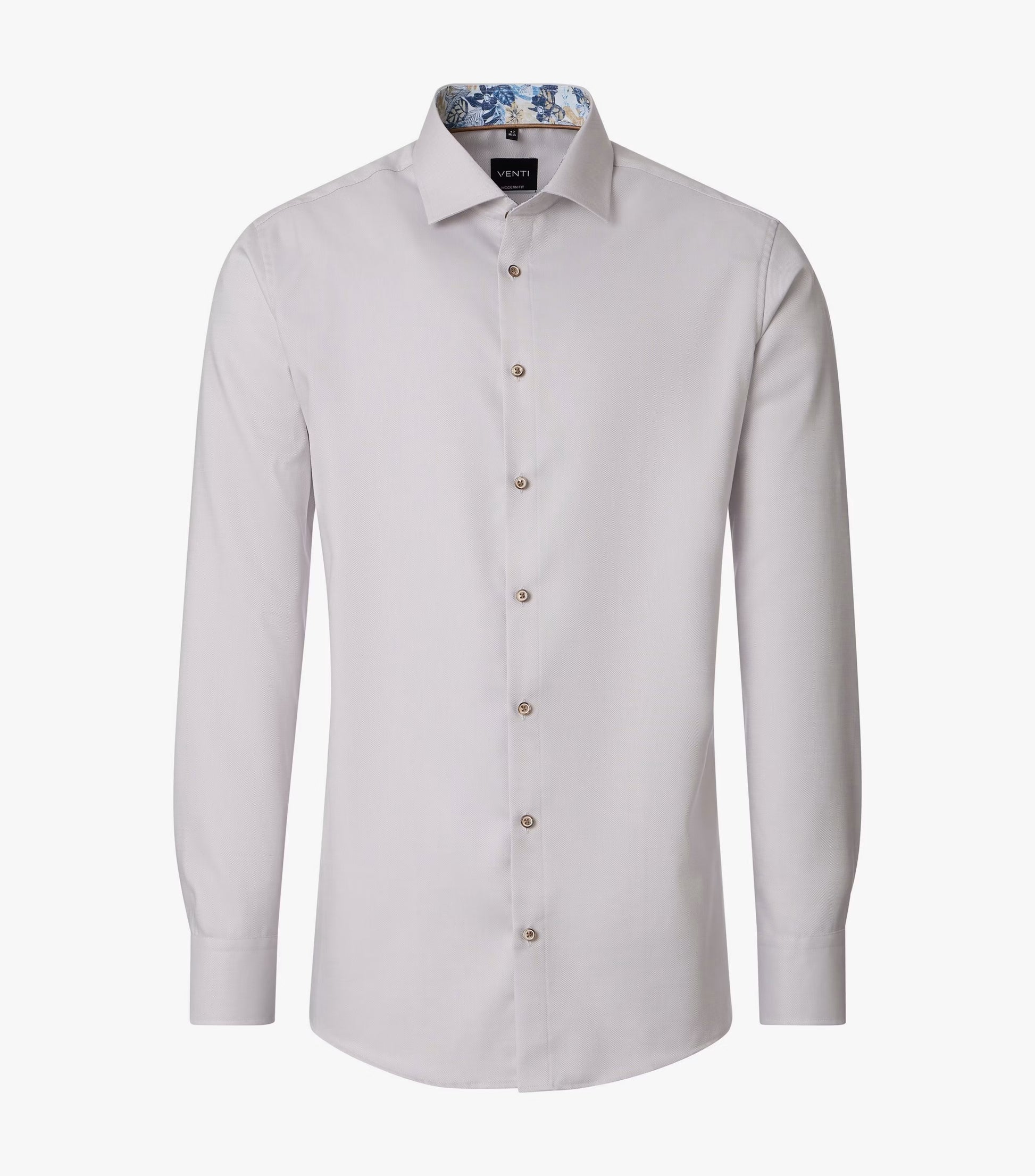 A light beige long-sleeve dress shirt with a button-down front and a patterned inner collar, displayed on a clean white background.