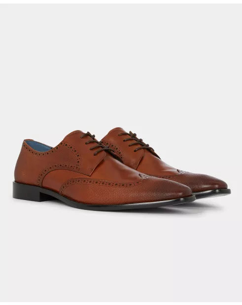 Pair of brown leather dress shoes on a white background