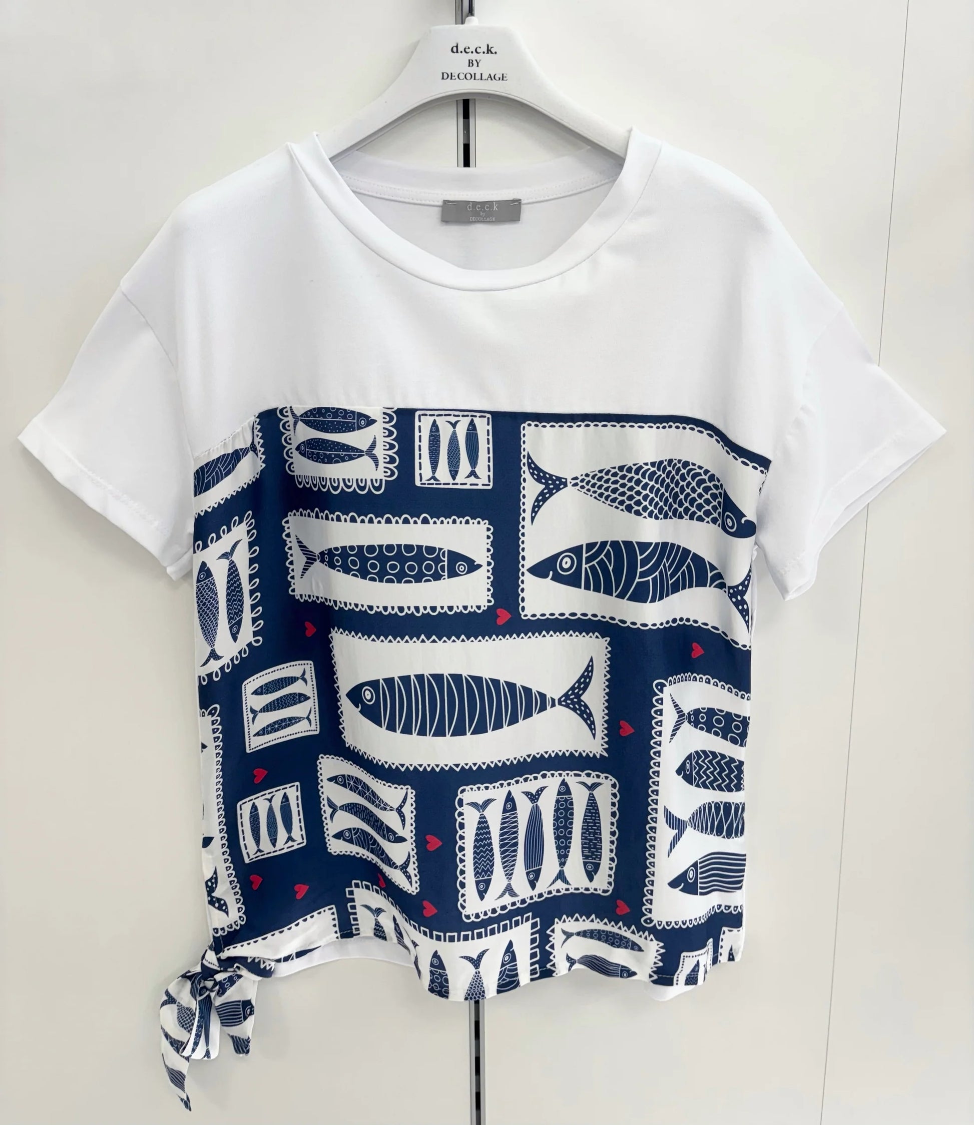 White t-shirt with blue fish pattern on a white background