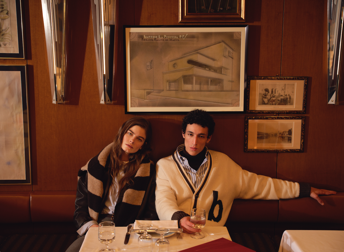 man & woman sitting beside each other at restaurant table