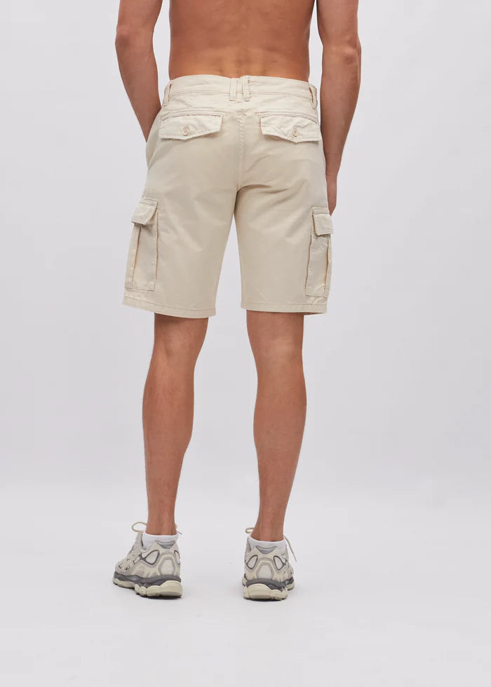 Person wearing beige cargo shorts on a plain background