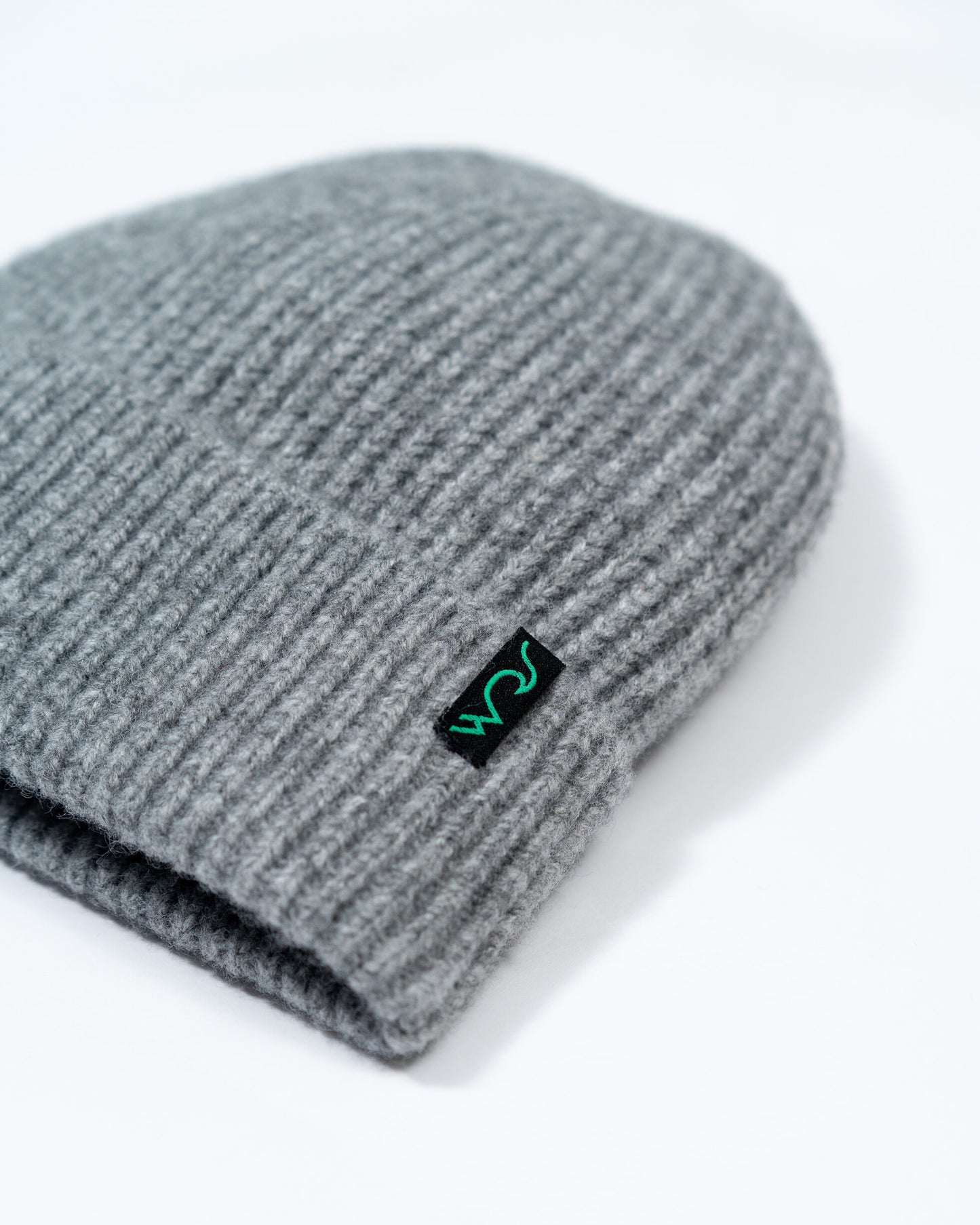 Gray knit beanie with a logo on a white background