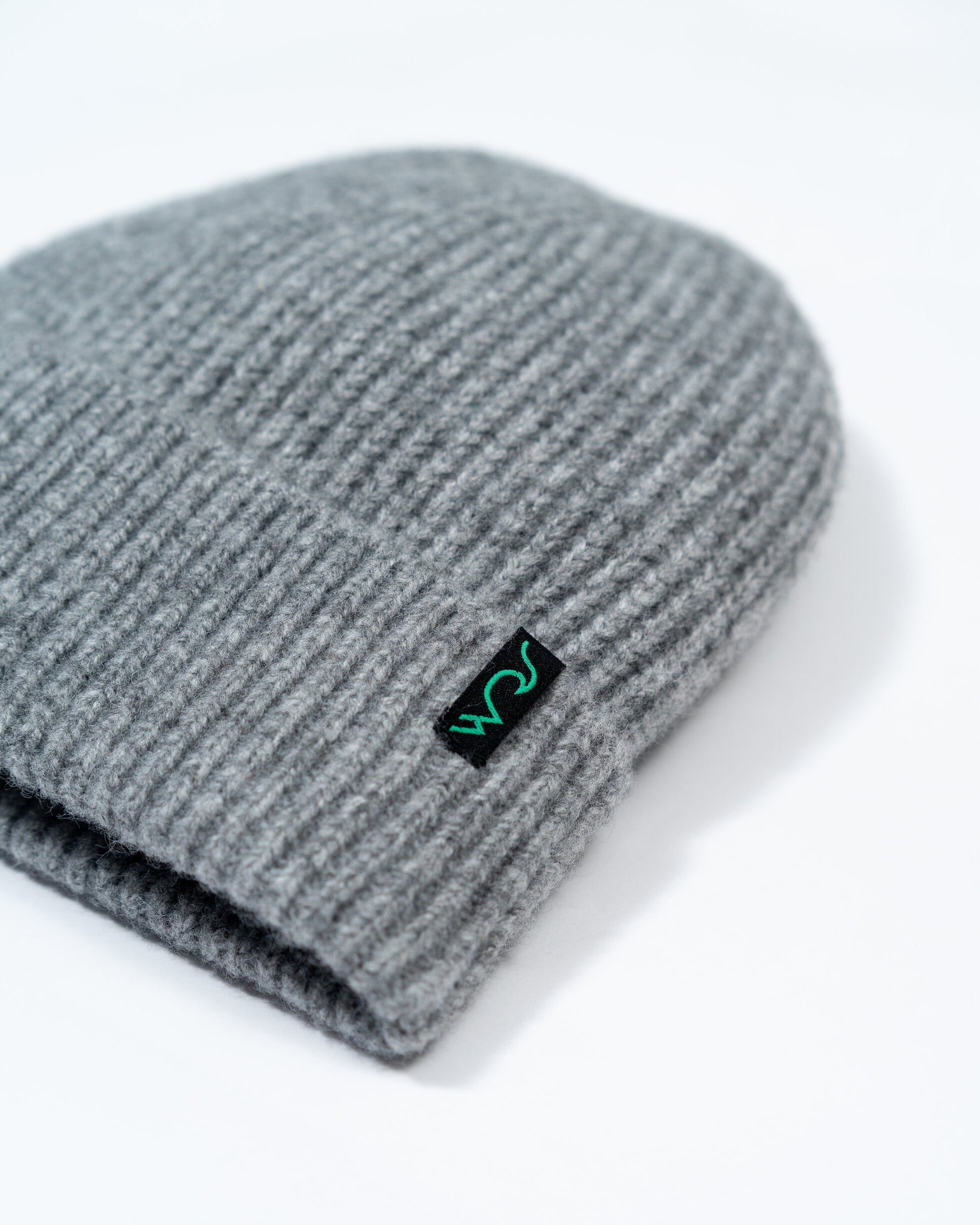 Gray knit beanie with a logo on a white background