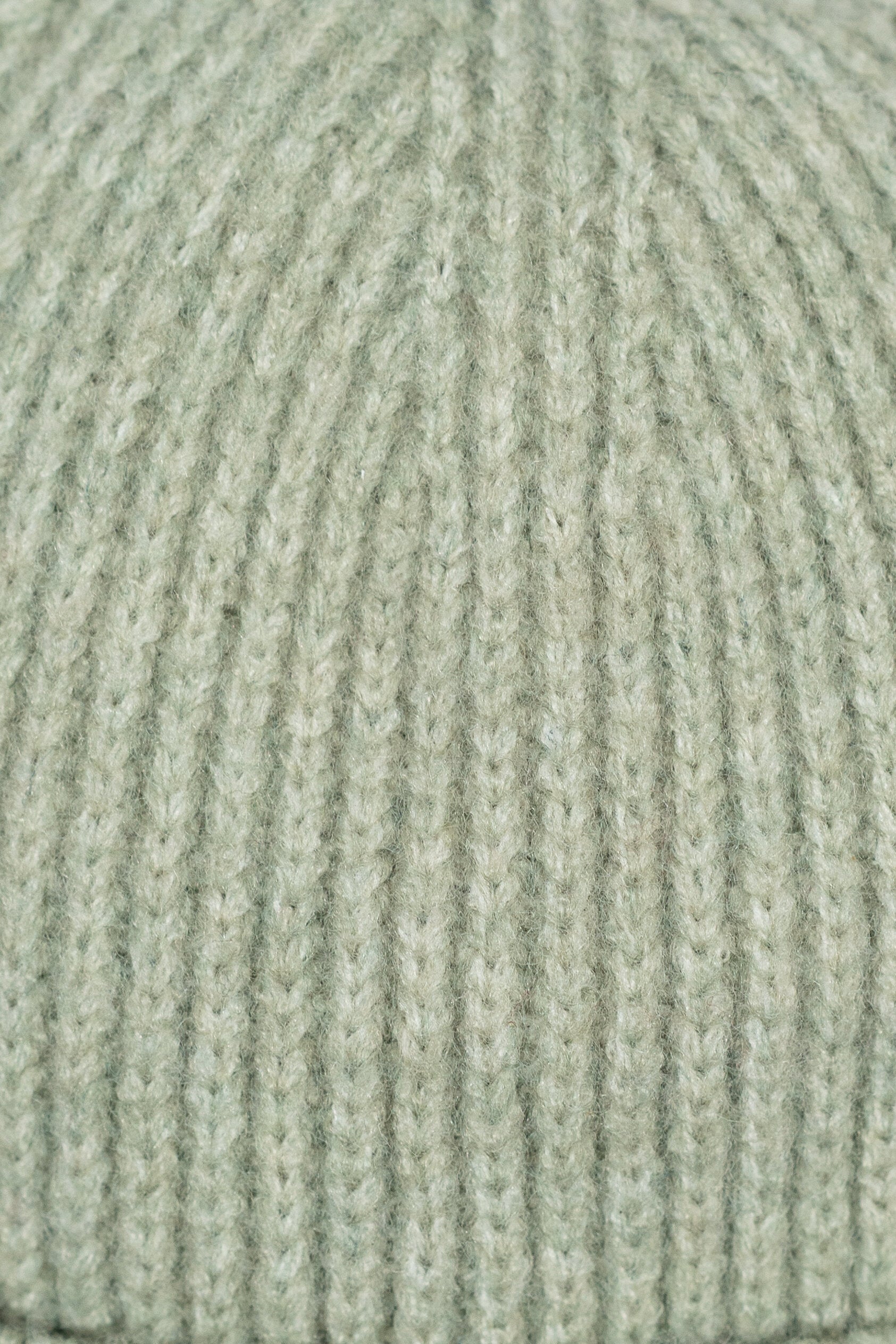 Close-up of a textured green fabric surface