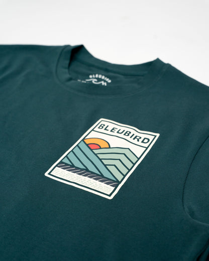 Green t-shirt with a graphic design and 'BLEUBIRD' branding on a white background