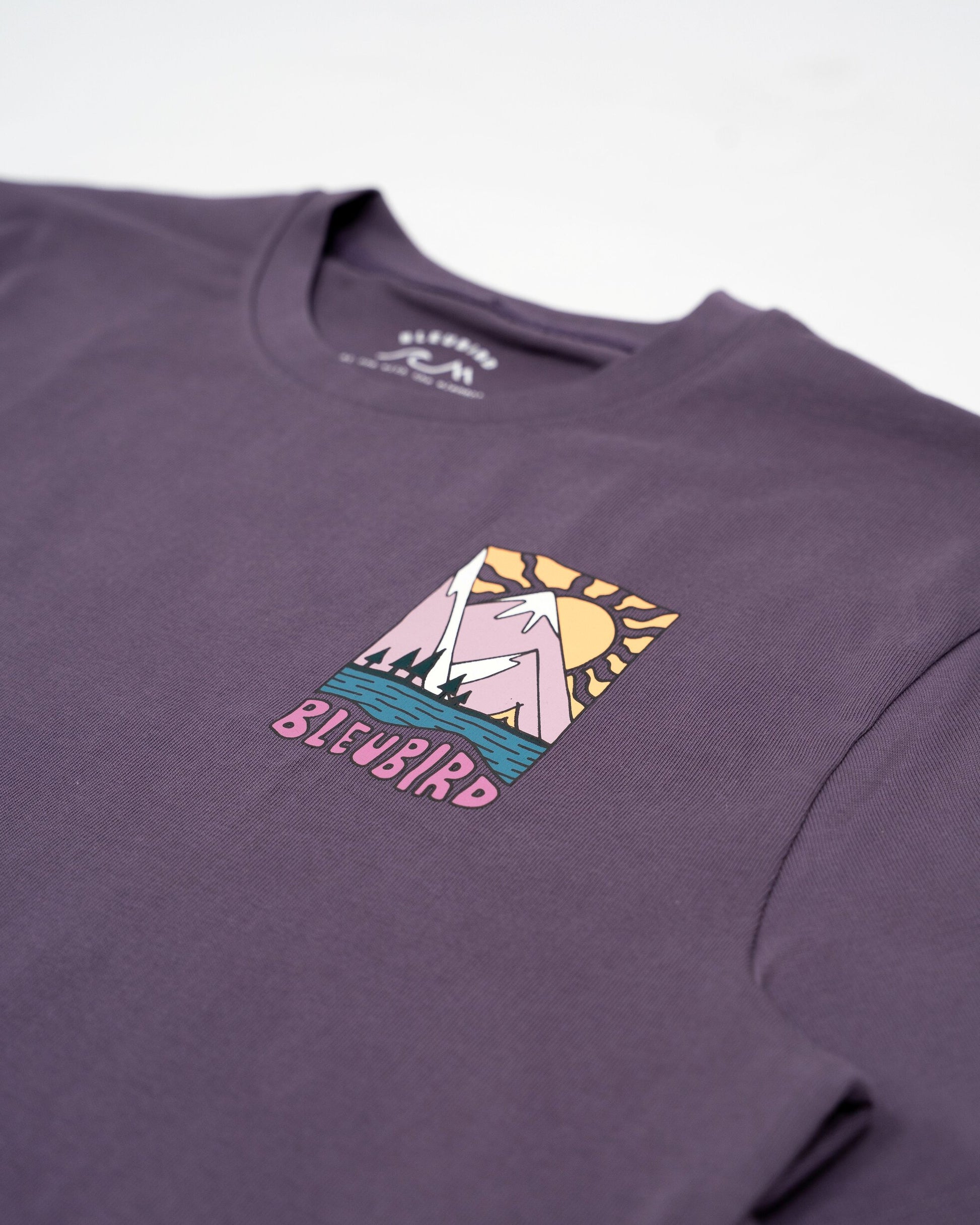Purple t-shirt with a graphic design and 'Bluebird' text on a white background