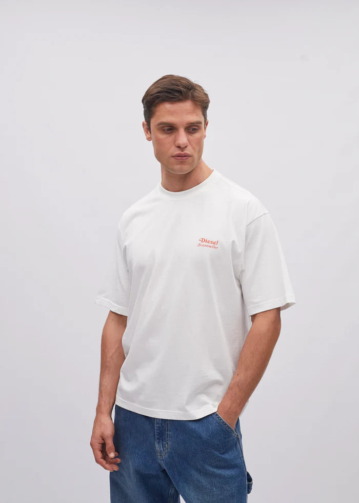Man wearing a white t-shirt with a small logo on a plain background