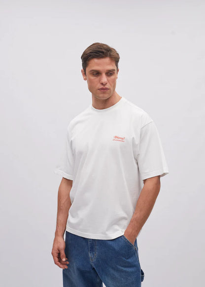 Man wearing a white t-shirt with a small logo on a plain background