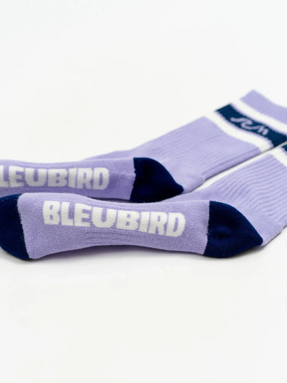 Pair of purple socks with 'BLEUBIRD' branding on a white background