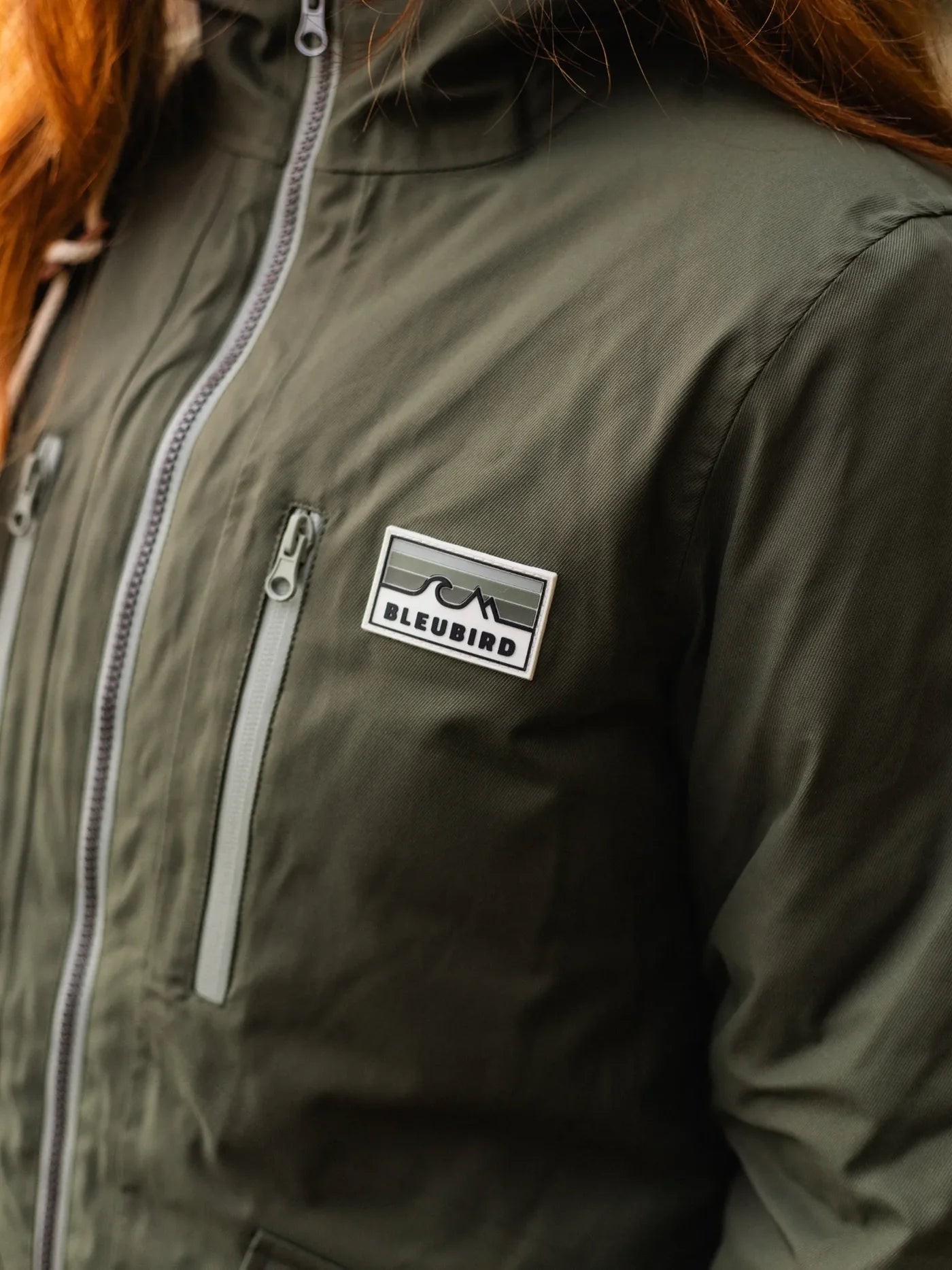 Green jacket with Bleubird logo on a person wearing it