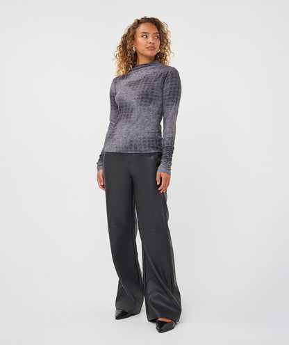 A woman modeling a gray textured long-sleeve mock neck top and black wide-leg trousers against a plain white studio background.