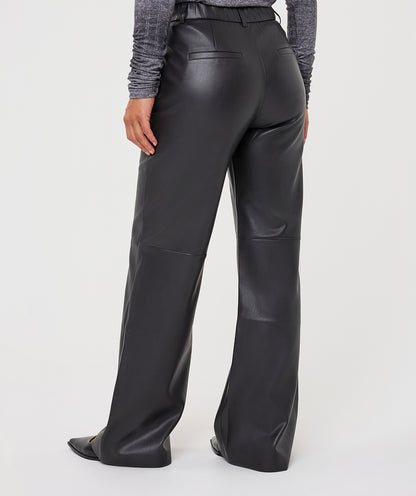 Black wide-leg faux leather pants shown from the back on a model, paired with a gray textured long-sleeve top, against a light gray studio background.