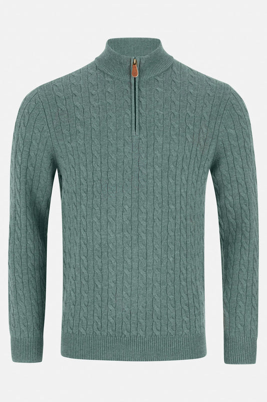 Green cable knit sweater with a quarter zip on a light gray background