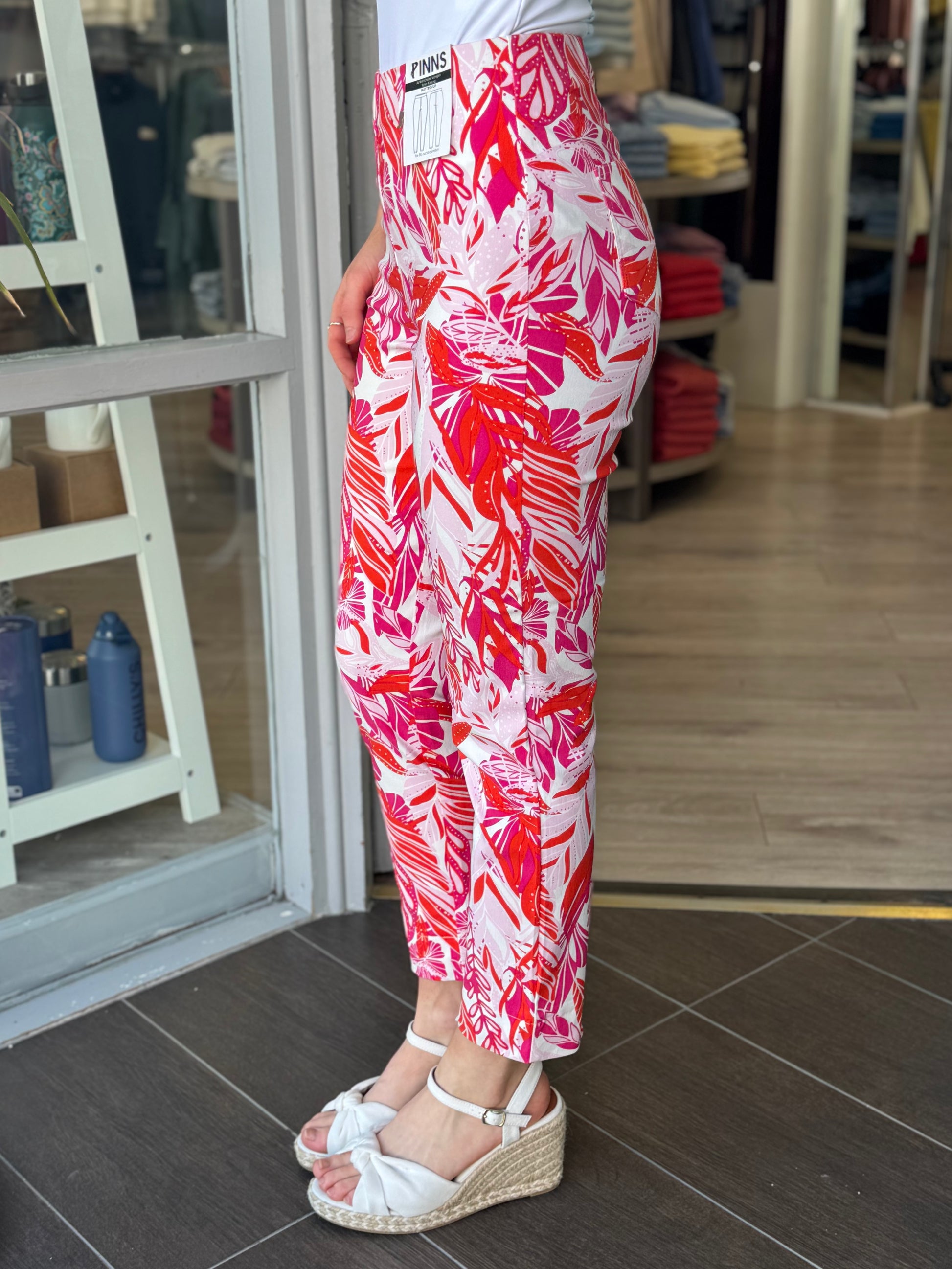 Person wearing red and white patterned pants in a store setting