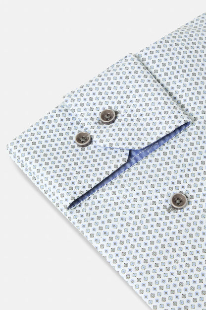 Close-up of a light blue and white patterned dress shirt cuff with brown buttons and a blue inner lining.