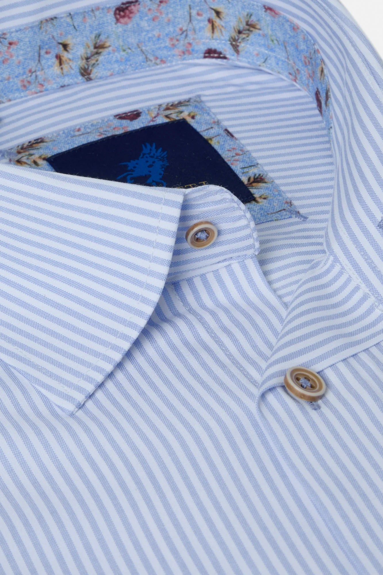 Close-up of a light blue striped shirt with floral lining